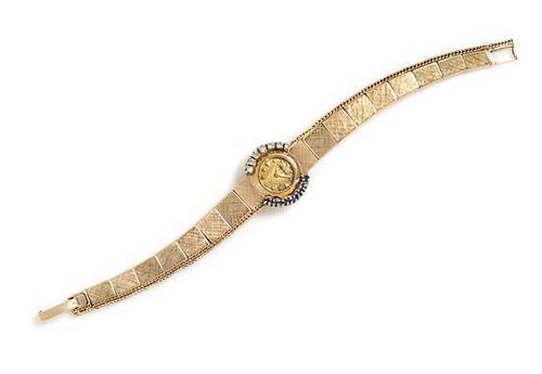 A 14 Karat Yellow Gold, Diamond and Sapphire Wristwatch, MOBA, 9.60 dwts.