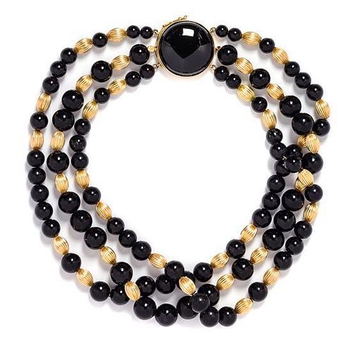 * A Triple Strand Yellow Gold and Onyx Bead Necklace, 63.30 dwts.