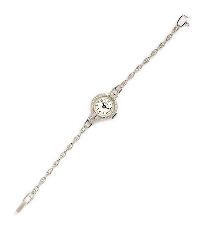 A Platinum, 14 Karat White Gold and Diamond Wristwatch, Croton, 8.80 dwts.