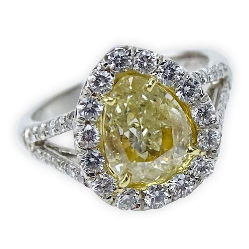 Approx. 2.0 Carat Pear Shape Fancy Intense Yellow Diamond, .65 Carat Round Brilliant Cut Diamond, Platinum and 18 Karat Yellow Gold Engagement Ring.