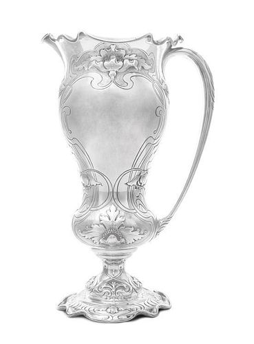 * An American Silver Tall Water Pitcher, Redlich & Co., New York, NY, Circa 1900, on a shaped domed base chased with lobes and r