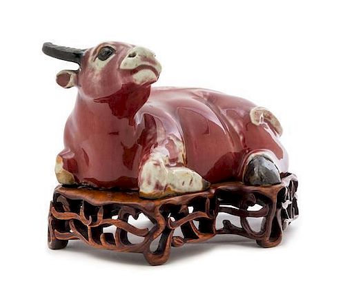 A Copper Red Glazed Porcelain Figure of a Water Buffalo Height 6 3/4 inches. 紅釉水牛臥像，19世纪，高6.75英吋