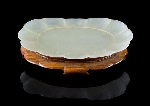 * A Pale Celadon Jade Dish Length 4 3/8 inches. 青白玉菊形小碟，長4.375英吋
