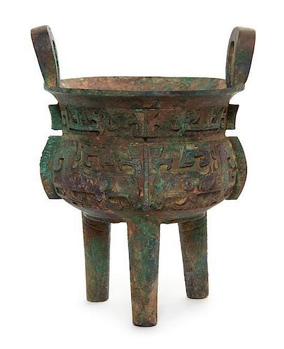 * A Bronze Tripod Li Ding Height over handles 11 inches. 青銅鬲，高11英吋