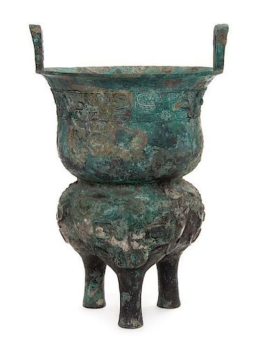 * A Bronze Ritual Tripod Xian Height over handles 15 7/8 inches. 青銅甗，高15.875英吋