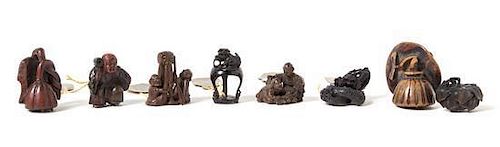 Eight Carved Wood Netsuke Height of largest 2 1/4 inches.