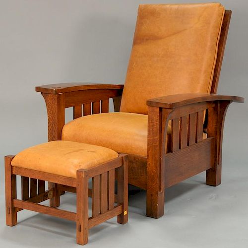 L & JG Stickley Morris oak chair and ottoman with leather seats.