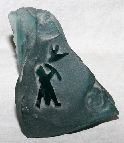 CARVED GLASS OF AN ESKIMO HUNTING A BIRD