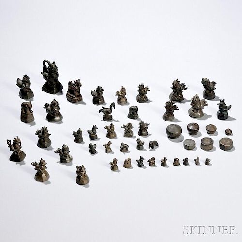 Forty-six Mostly Bronze Mat Weights and Finials with a Glazed Wood Display Case 一柜子46件铜制砝码、秤砣和垫子，高0.625-2.75英寸，