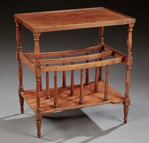 English Carved Mahogany Canterbury, 20th c., the dished rectangular top on ring turned tapered legs with French toes joined by a lower shaped stretche