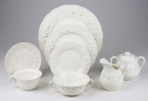 63 pcs Wedgwood cream Queensware with embossed grape vine border; incl. serving bowls, dinner plates, sugar & creamer, bouill