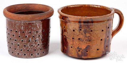 Two redware colanders, 19th c., one handled with m