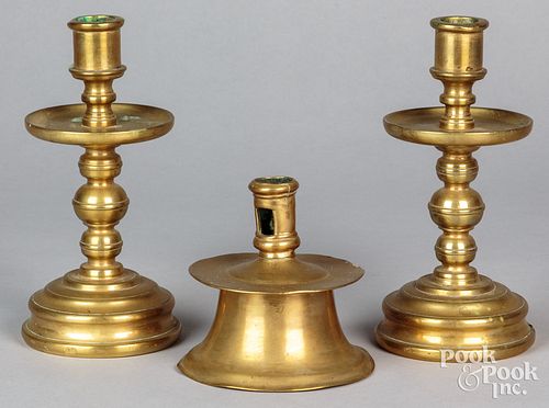 Three brass candlesticks, to include a capstan