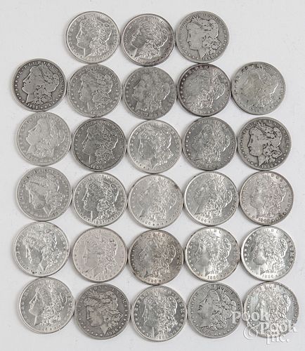 Twenty-eight Morgan silver dollars.