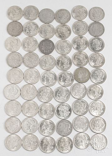 Fifty-four 1921 Morgan silver dollars.