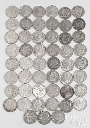 Fifty-one Morgan silver dollars.
