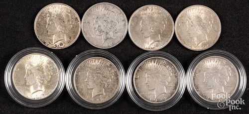 Eight Peace silver dollars.