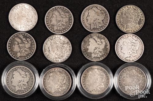 Twelve Morgan silver dollars.