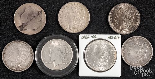 Seven silver dollars, to include 1882-CC.