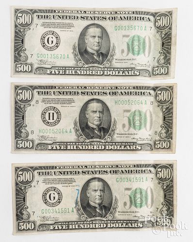 Three US 500 dollar notes.