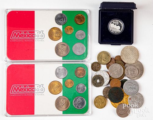 Foreign coins, to include an 8.4g silver coin.