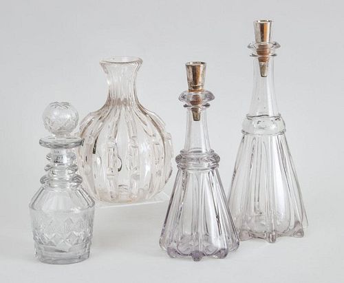 TWO 20TH CENTURY GRADUATED FLARED REEDED GLASS DECANTERS WITH SILVER-PLATED STOPPERS