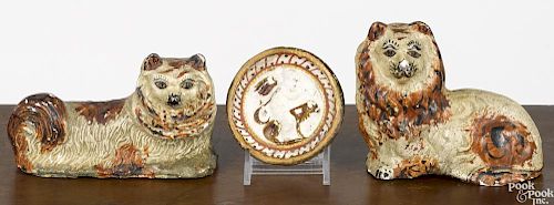 Two Pennsylvania chalkware lions, 19th c., together with a small roundel, tallest - 3 3/4''.