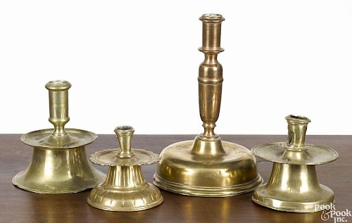Four brass candlesticks, 16th/17th c., to include three capstans and a Dutch bell base example