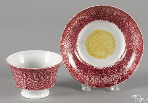 Red and yellow rainbow spatter bull's-eye cup and saucer.