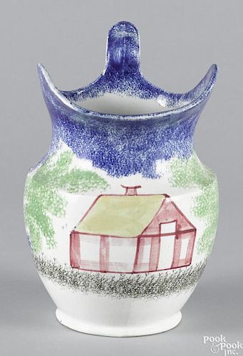 Blue spatter pitcher with schoolhouse decoration, 9 3/8'' h.