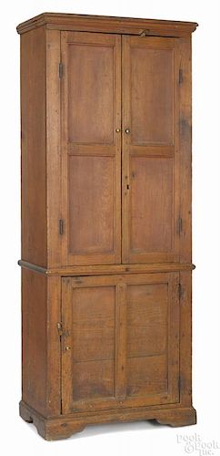 Southern hard pine cupboard, ca. 1810, with recessed panel doors and bracket feet, 66 1/2'' h.