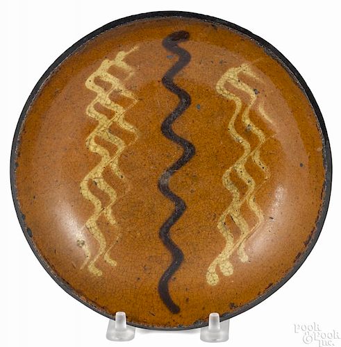 Pennsylvania redware pie plate, 19th c., with yellow and brown wavy slip lines, 6 3/4'' dia.
