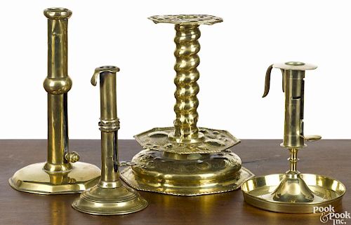 Four brass candlesticks, 18th/19th c., to include three slide ejectors and an embossed example