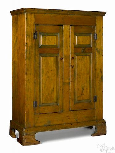 Southern pine cupboard, late 18th c., with raised panel doors and bold bracket feet