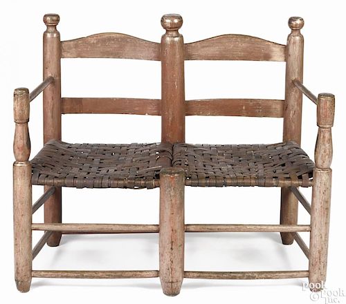 Child's painted ladderback settee, early 19th c., retaining an old salmon surface, 28'' h.