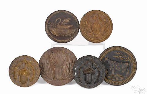 Six turned and carved butterprints, 19th c., to include an eagle, a cow, a swan, wheat