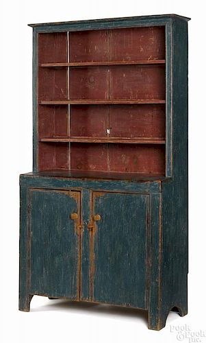 Painted pine stepback cupboard, early 19th c., retaining an old blue surface with red shelves