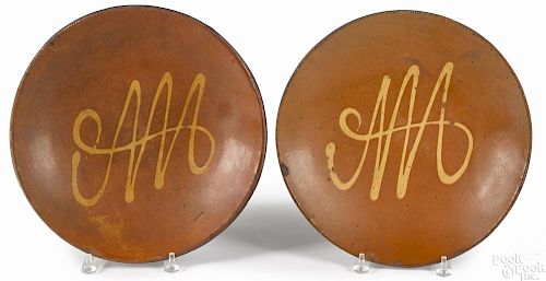Pair of Connecticut redware chargers, 19th c., with yellow slip decoration, 13 1/4'' dia.