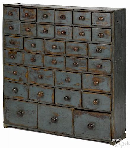 Pennsylvania painted poplar apothecary cupboard, ca. 1900, retaining a later blue surface, 41'' h.