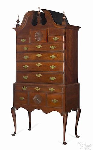 Connecticut Queen Anne cherry high chest, ca. 1765, with a bonnet top and fan carved drawers