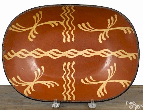 Pennsylvania redware loaf dish, 19th c., with vibrant yellow slip decoration, 11 1/4'' l.