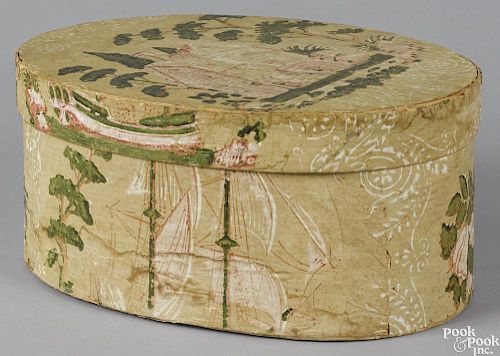 New England wallpaper hatbox, 19th c., decorated with a ship and a house, 6'' h., 13 1/4'' w.