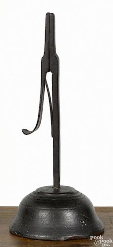 Wrought iron rush light holder, 19th c., mounted to a turned wood base with an old dark surface