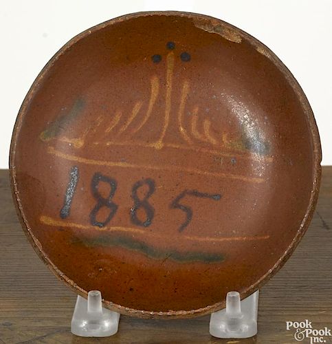 Miniature Pennsylvania redware plate, dated 1885, with yellow and green slip highlights, 5'' dia.