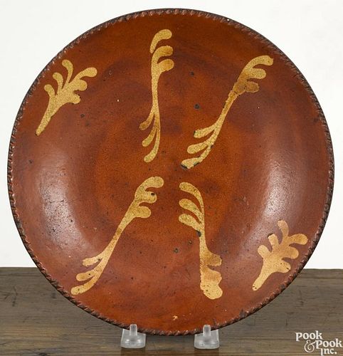 Redware pie plate, 19th c., with yellow slip decoration, 9 7/8'' dia.
