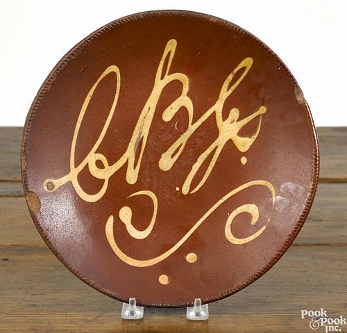 Connecticut redware pie plate, 19th c., with yellow slip ABC, 10 1/4'' dia.
