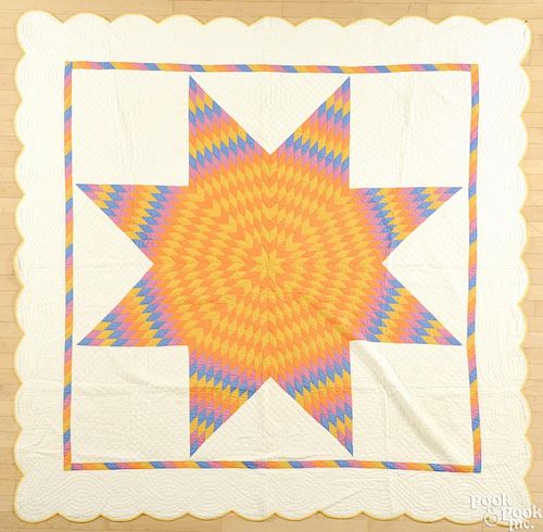 Pennsylvania lone star quilt, early 20th c., with a scalloped edge and pieced border, 82'' x 82''.