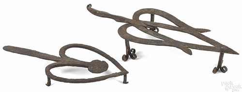 Two wrought iron trivets, 19th c., the larger with trefoil feet, 9 1/2'' l. and 12 1/2'' l.