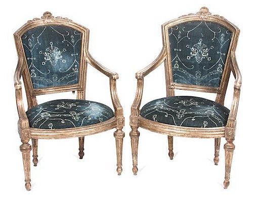 A Pair of Louis XVI Style Giltwood Fauteuils Height of each 39 1/4 inches.