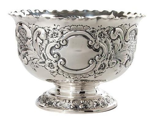 * An English Silver Circular Footed Bowl, Goldsmiths and Sliversmiths, Co., London, 1920, the sides worked to show floral decora